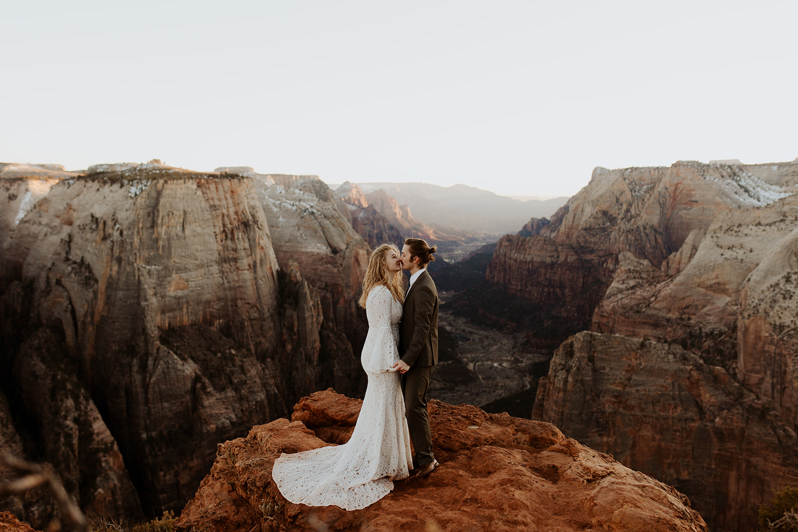 Couple holds hands at sunset elopement in Zion National Park