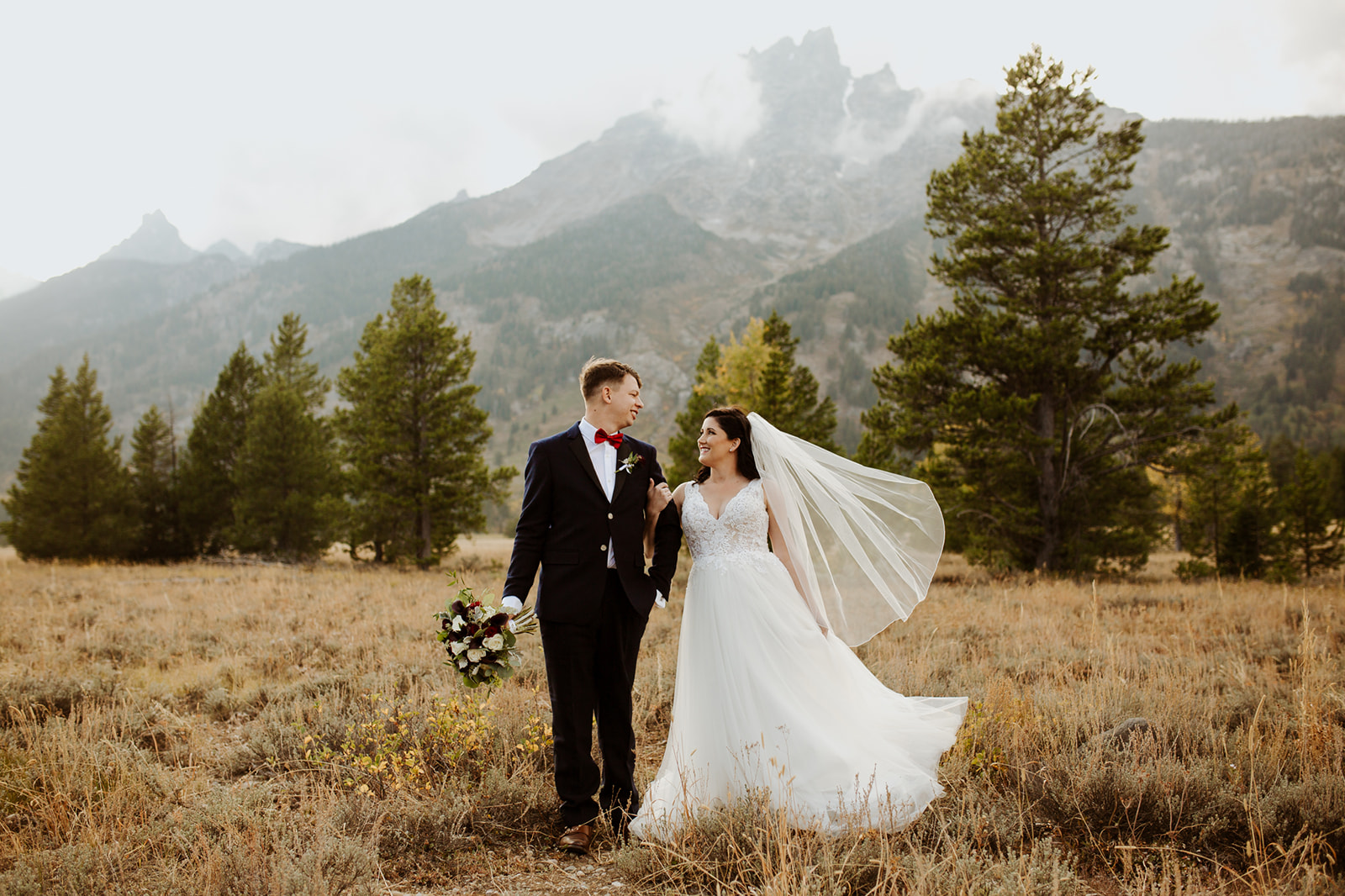 Couple holds hands at Tetons elopement