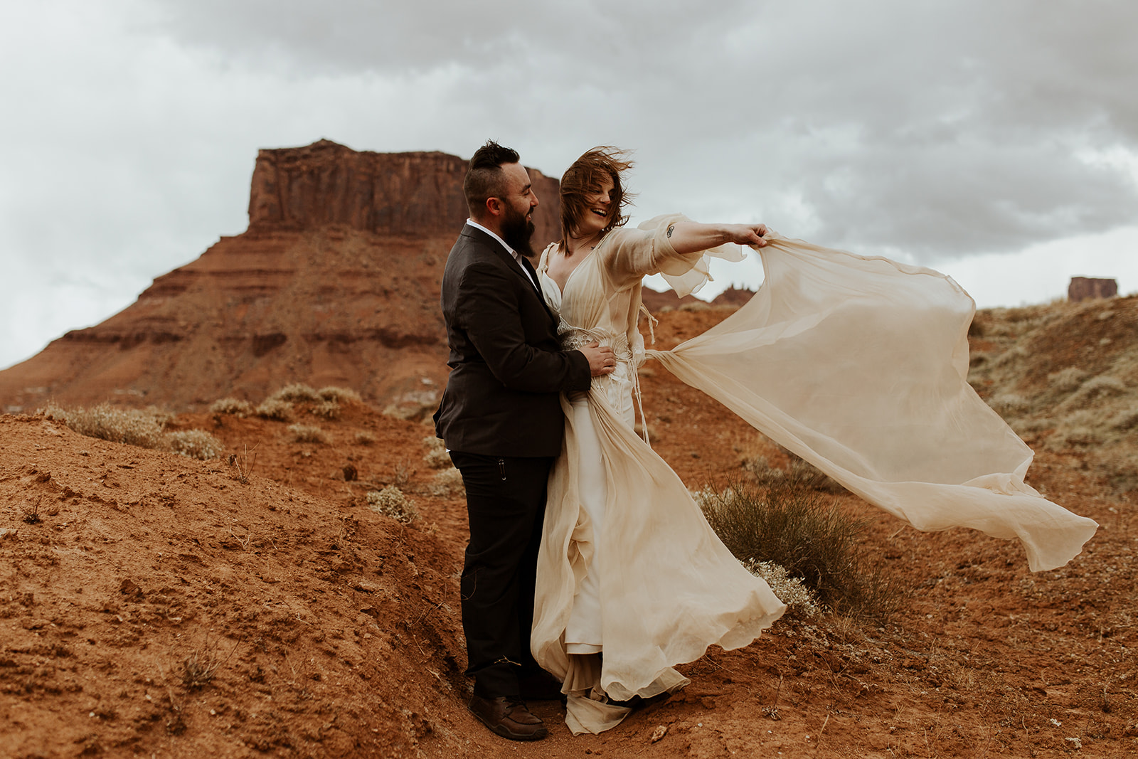 Couple embraces at Moab adventurous elopement