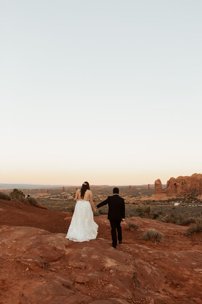 couple stands on top of rock at red rock overlook 