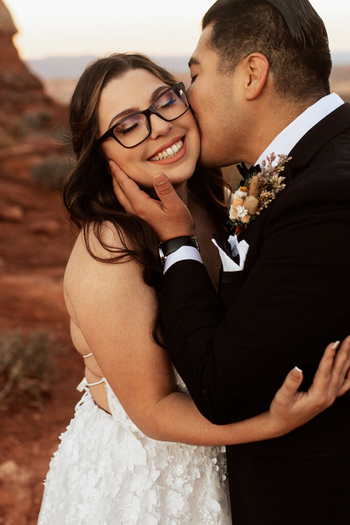 couple embraces kissing at outdoor elopement
