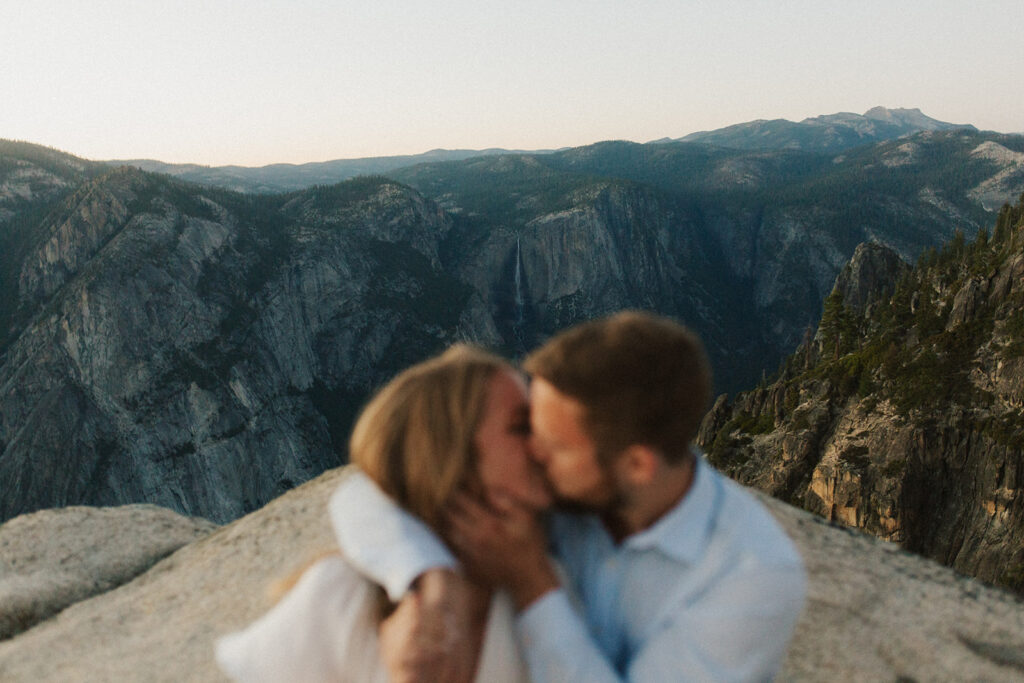 couple kisses at sunset Taft Point elopement