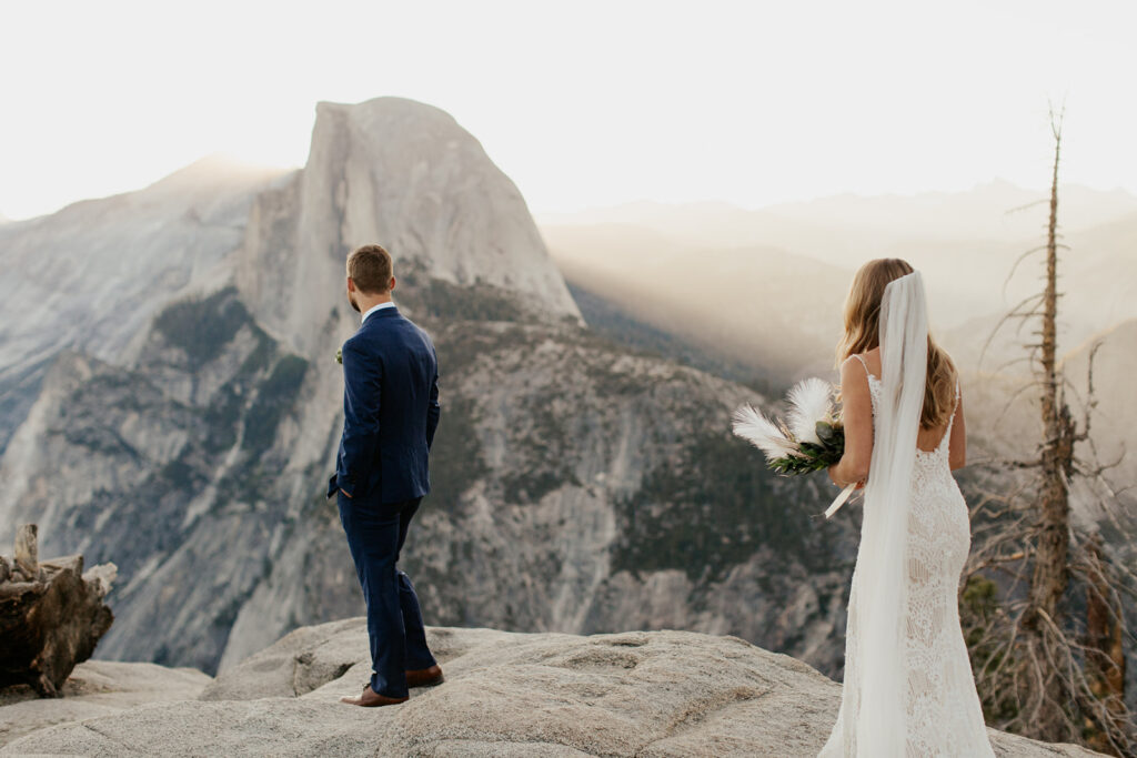 couple has first look at Glacier Point during sunrise elopement