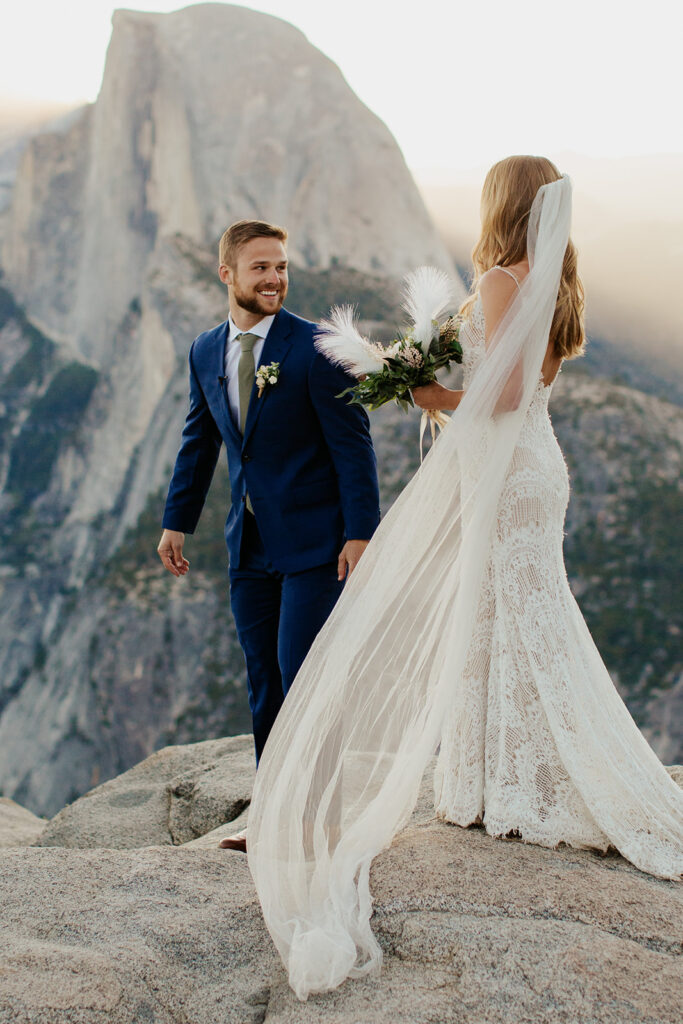 couple has first look at Glacier Point during sunrise elopement