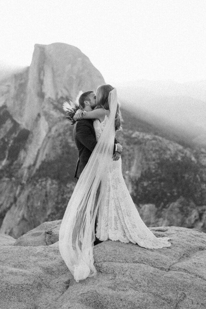 couple kisses at Glacier Point elopement