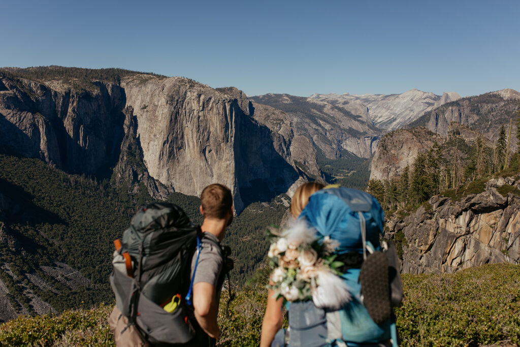 couple looks over Yosemite Valley wearing Yosemite backpacking gear