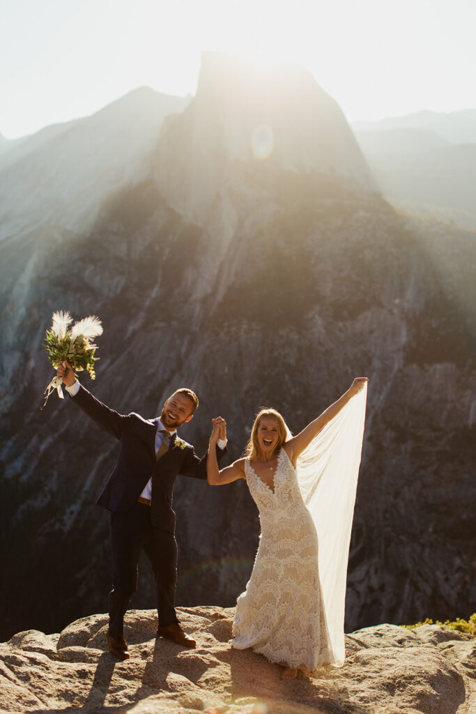 couple cheers at Half Dome sunrise elopement