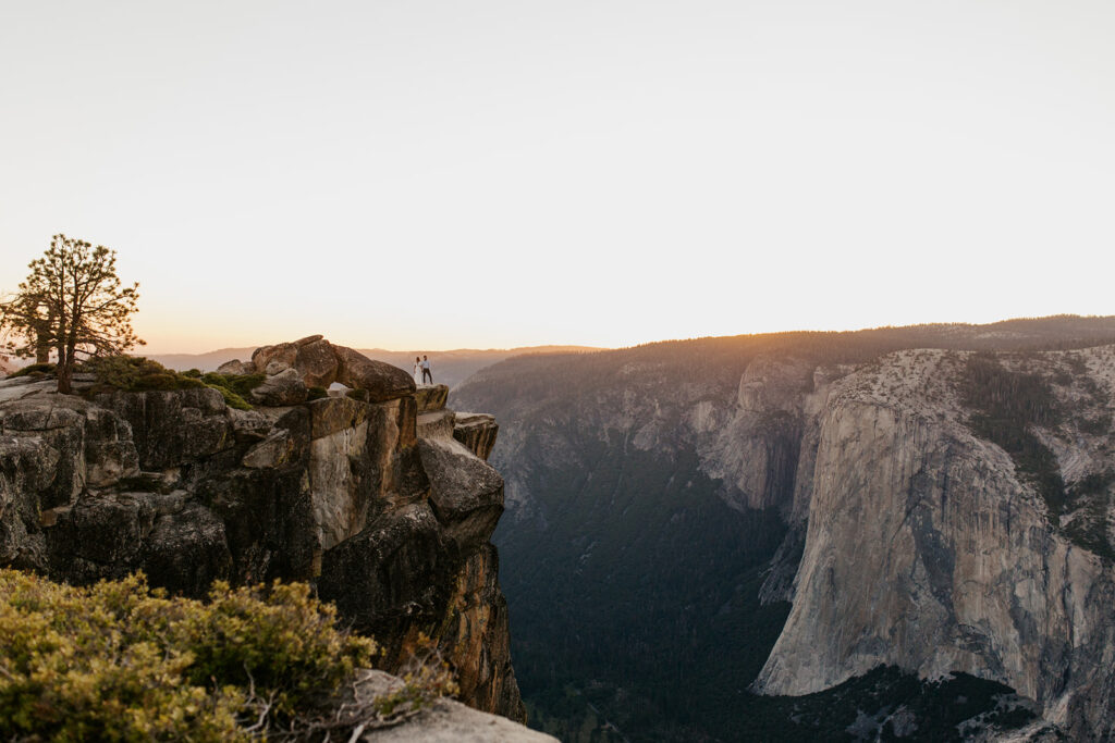 couple stand on sunset overlook at Taft Point elopement