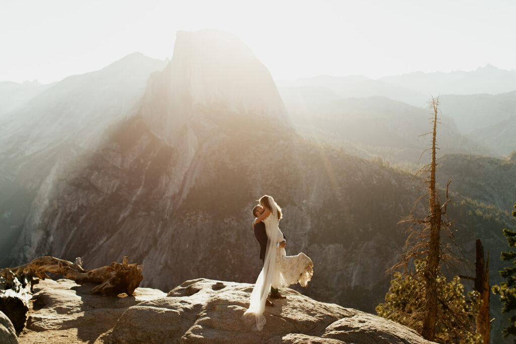 couple kisses at Glacier Point at Yosemite elopement