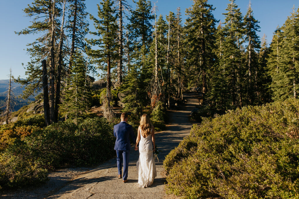 couple walks through woods at Yosemite elopement