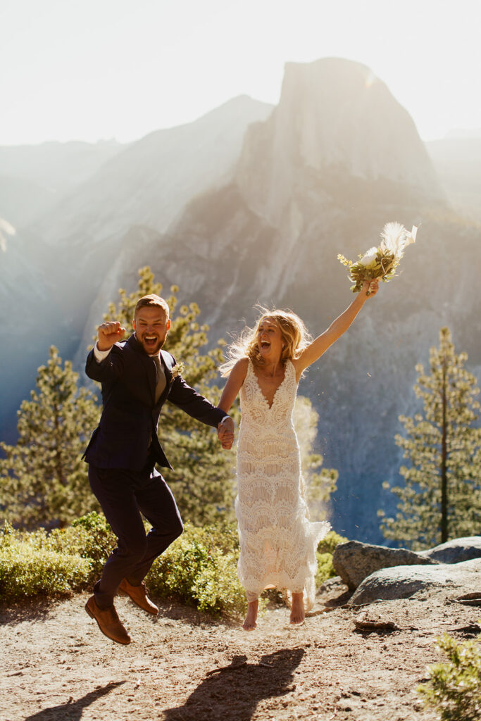 Couple jumps holding hands at Glacier Point elopement