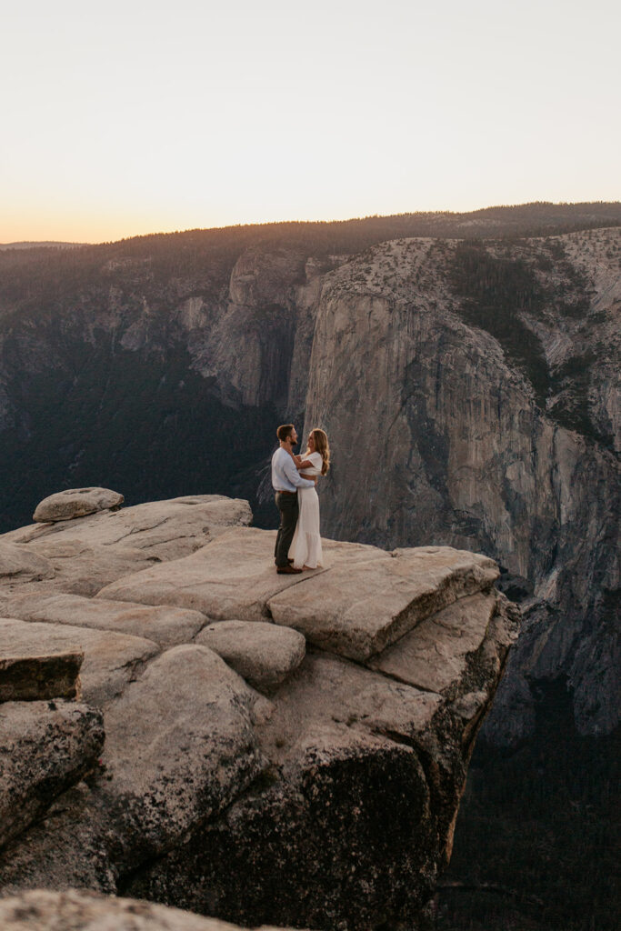 couple stand on sunset overlook at Taft Point elopement