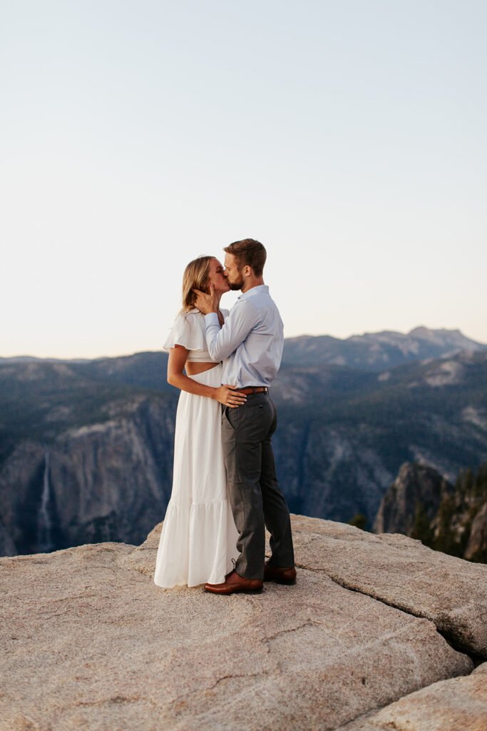 couple kisses at Taft Point Yosemite overlook