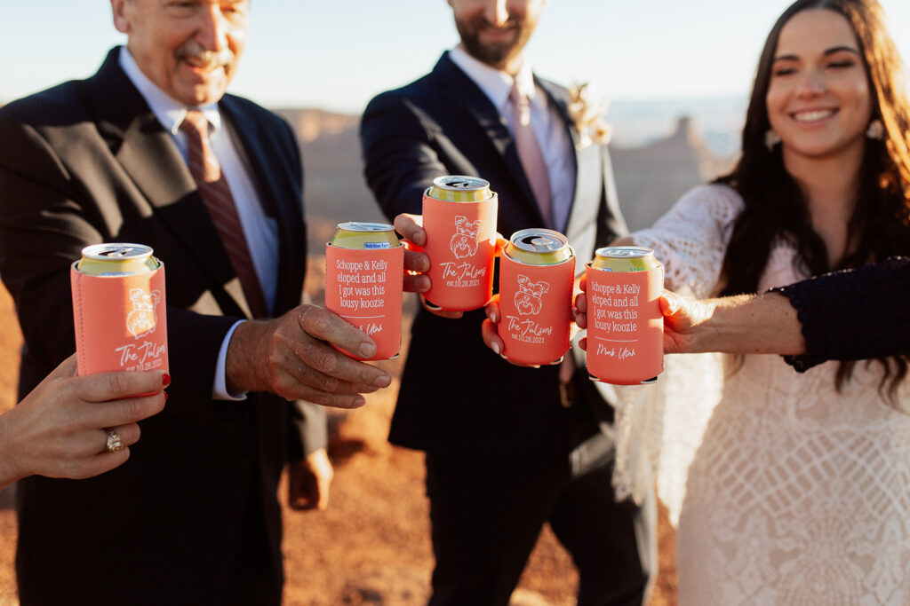 couple cheers with family at Moab adventure elopement