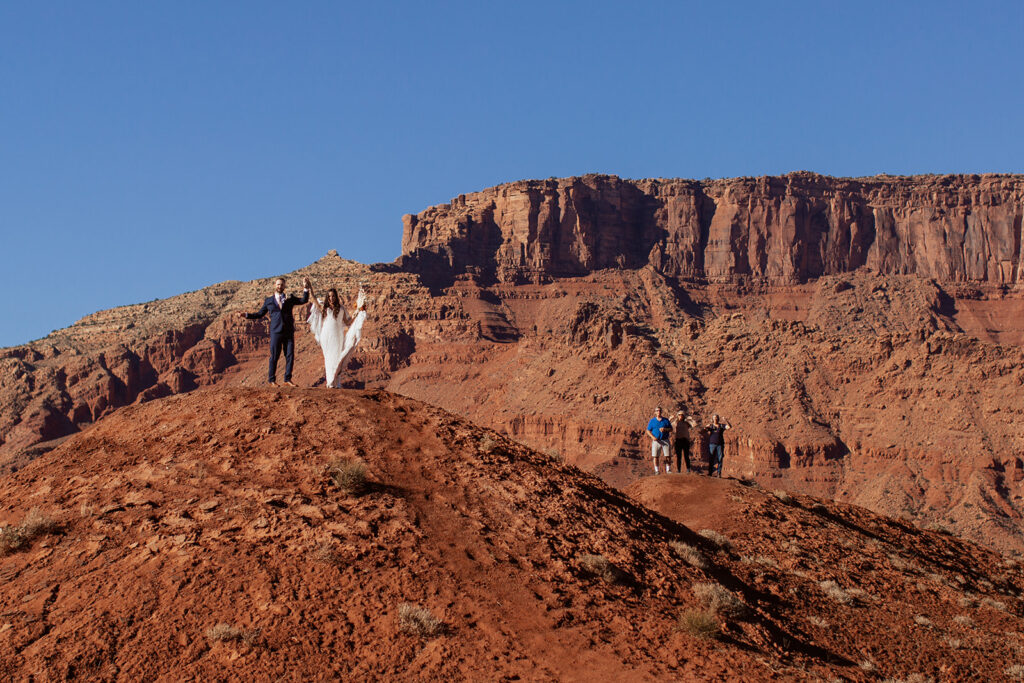 couple stands together on hill at Castle Valley elopement