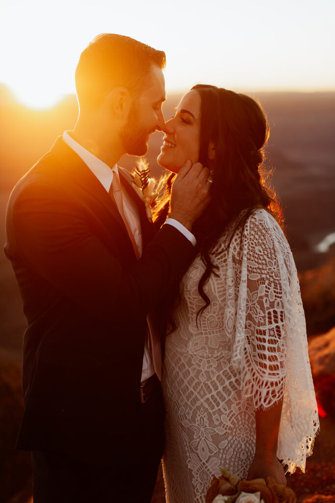couple kisses at Dead Horse Point State Park sunrise elopement