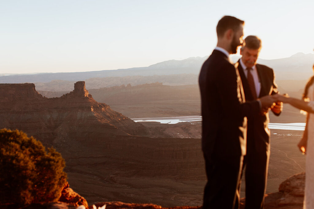 couple exchanges vows at Moab adventure elopement