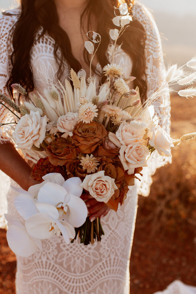 bride holds boho wedding bouquet