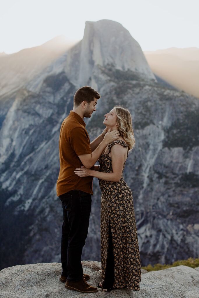 couple embraces at Glacier Point overlook engagement