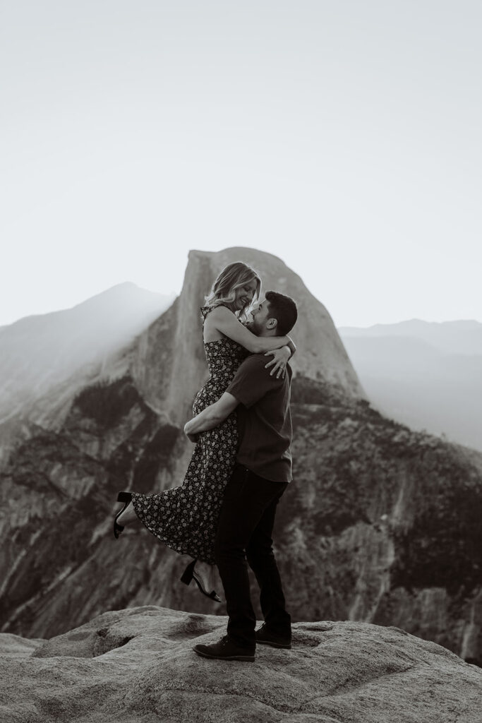 couple embraces at Glacier Point Yosemite overlook