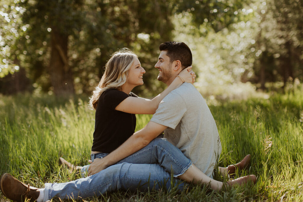 couple sits in each other's lap at engagement session