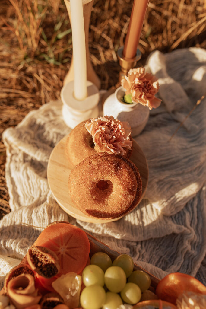 donuts with flowers on blanket at wedding day picnic