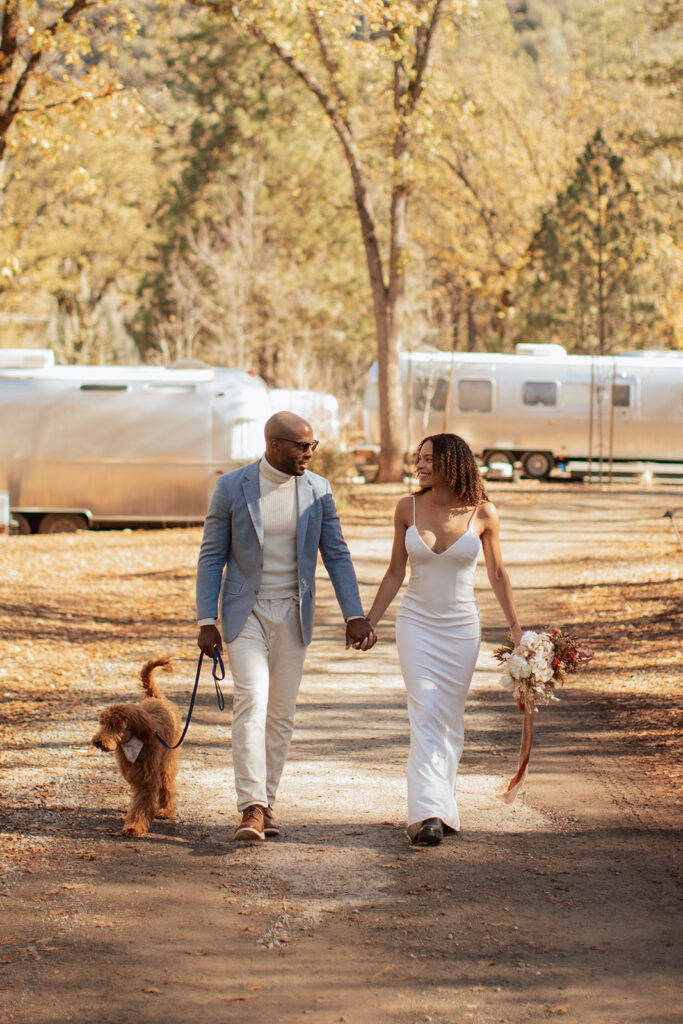 couple walks dog at outdoor Yosemite elopement