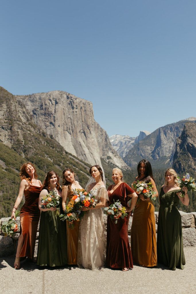 bride poses with bridesmaids at Yosemite Tunnel View