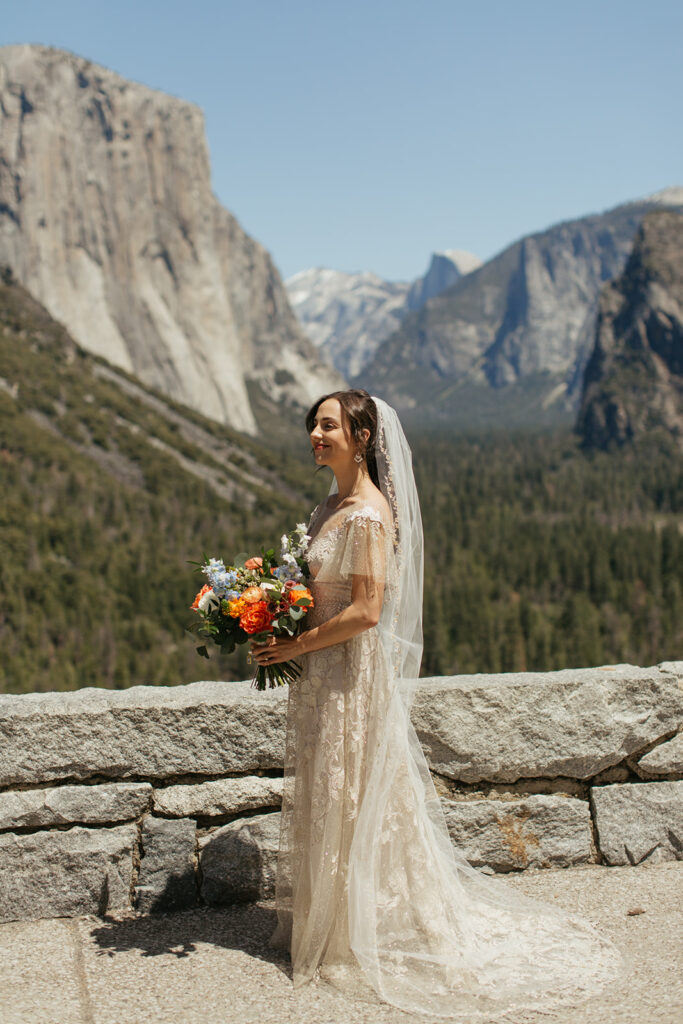 bride holds wedding bouquet in Tunnel View during wedding first look