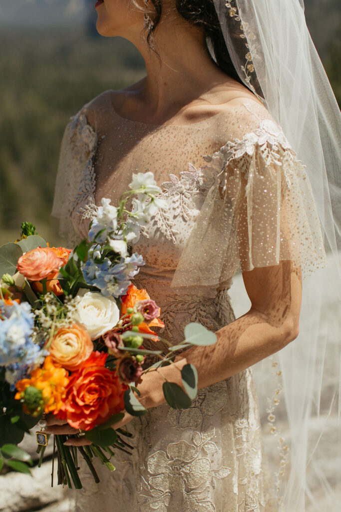 bride holds colorful wedding bouquet