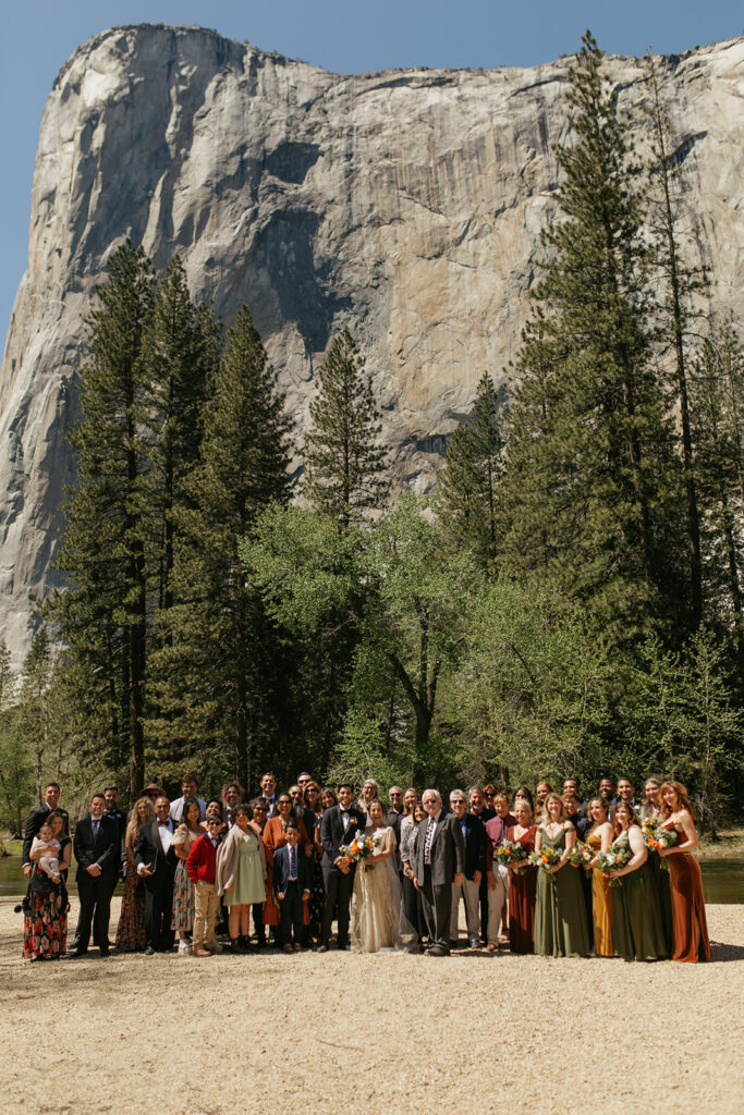 couple stands with all wedding guests at Yosemite Valley wedding