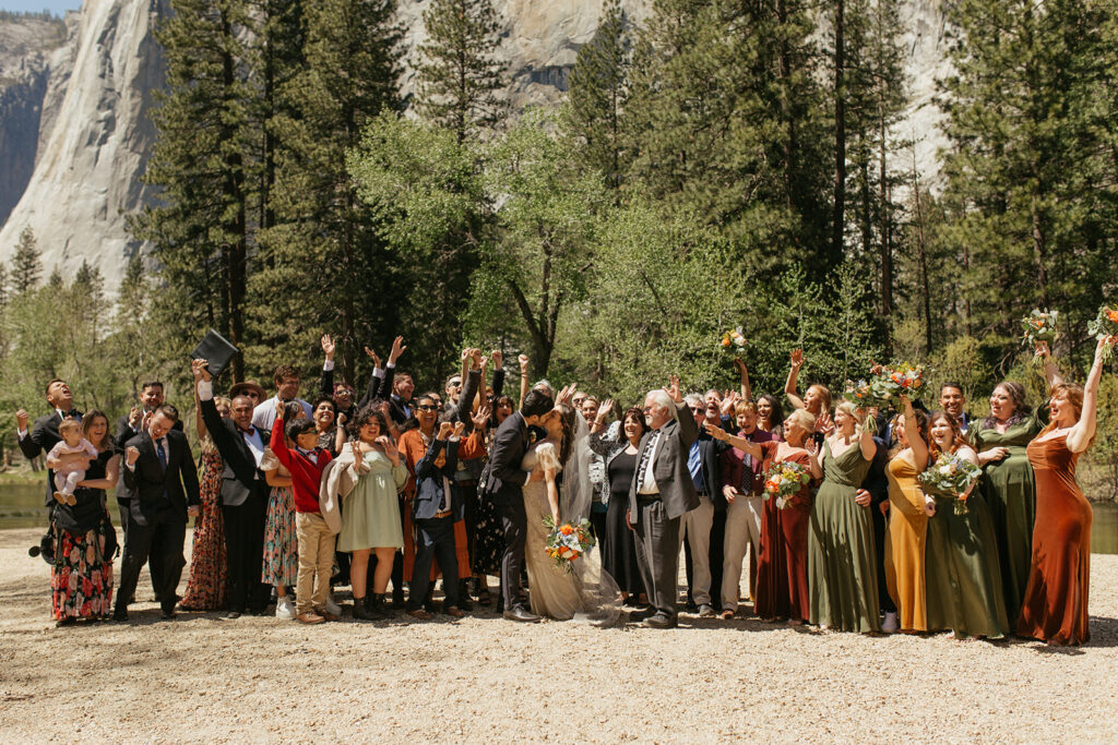 couple kisses with all wedding guests at Yosemite Valley wedding