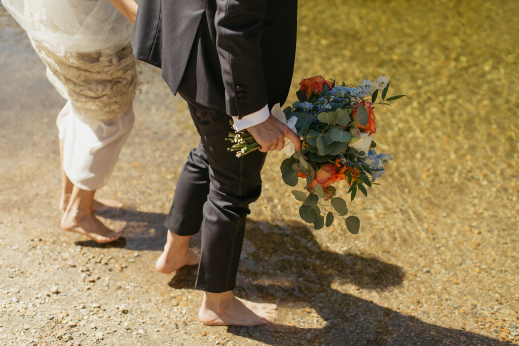 couple stands in Merced River elopement
