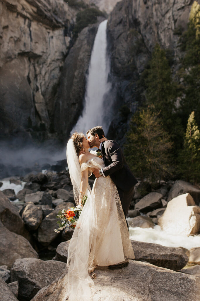 couple kisses at Yosemite falls elopement