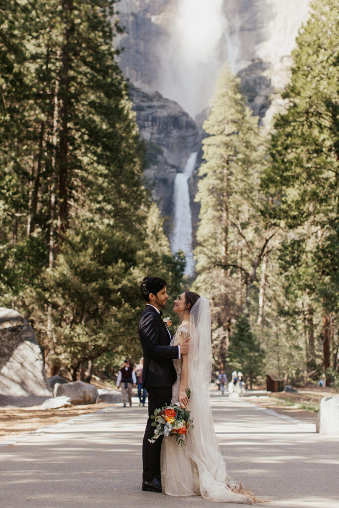couple embraces at Yosemite falls elopement