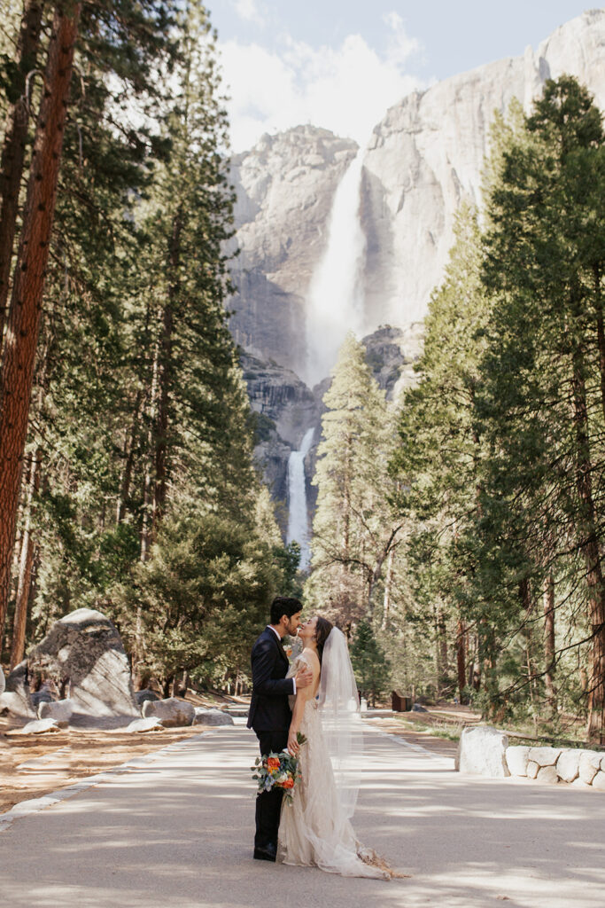 couple kisses beside Yosemite Falls