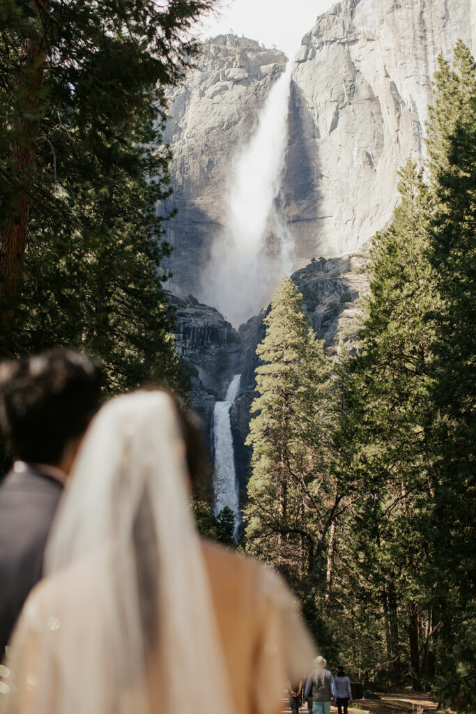 couple embraces beside Yosemite Falls
