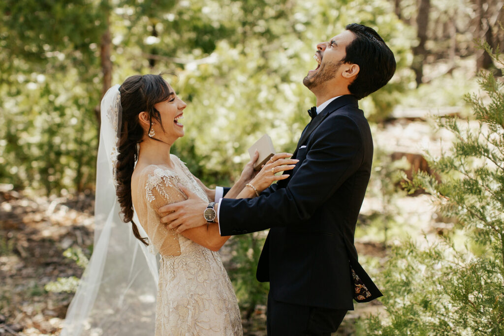 couple laughs together during wedding first look