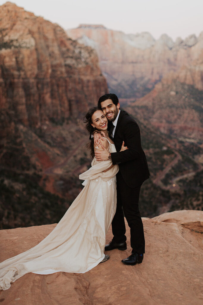 couple embraces at outdoor mountain top elopement