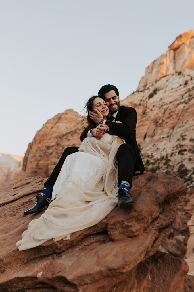 couple embraces at outdoor mountain top elopement