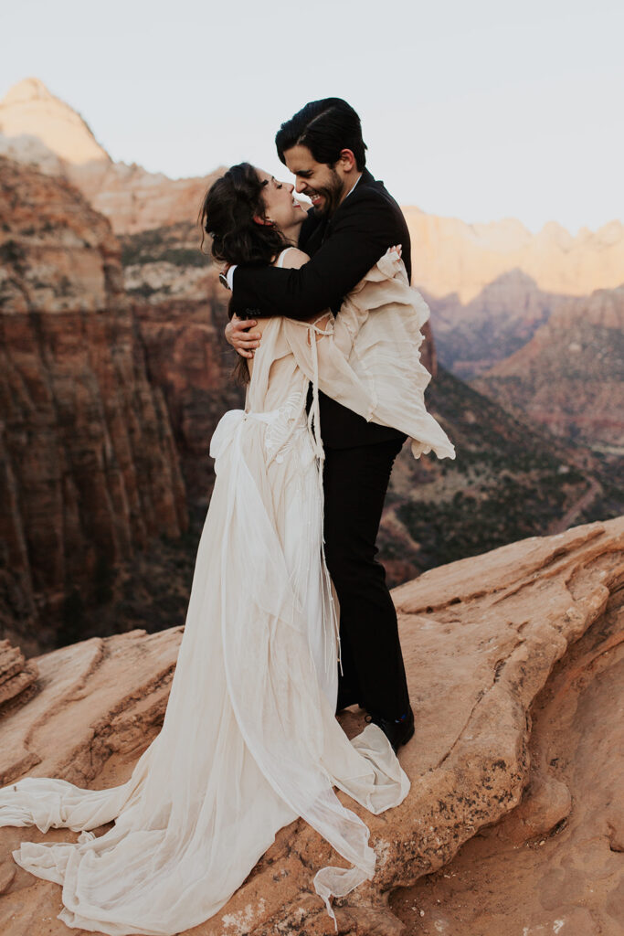 couple elopes on overlook at Zion National Park wedding